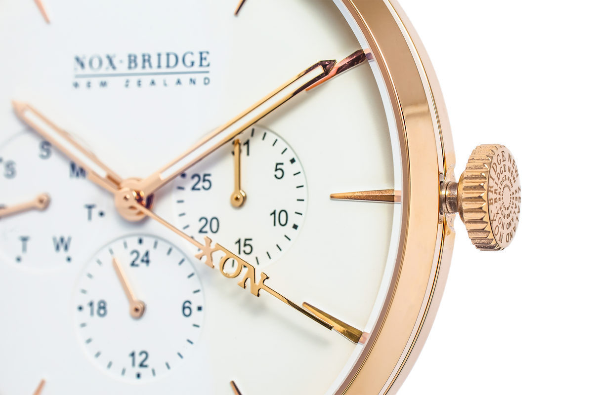 Close-up of rose gold chronograph watch dial with subdials, rose gold hands, and Noxbridge branding