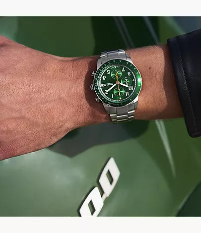 Fossil Sport Tourer green chronograph watch worn on wrist with silver steel bracelet